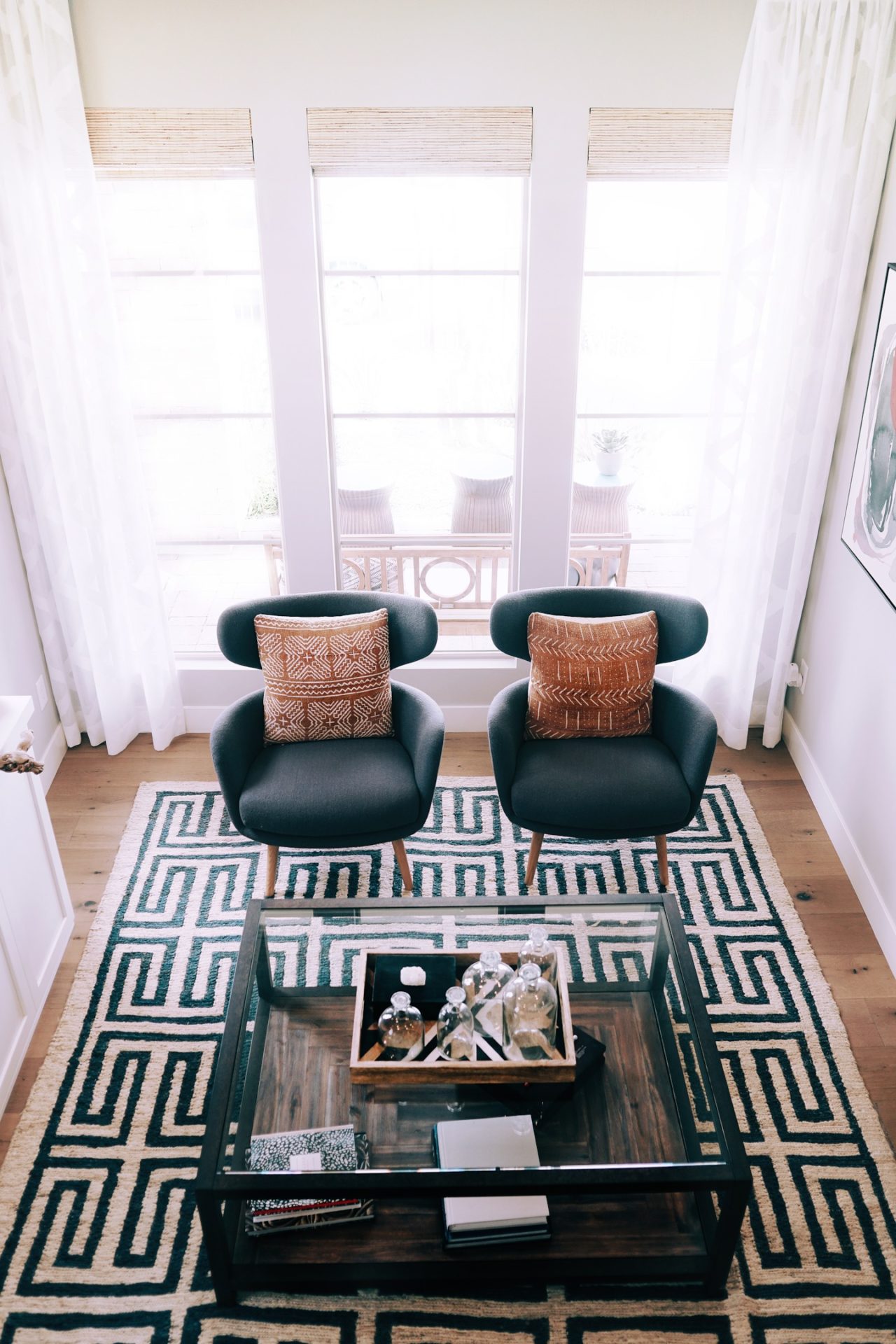 Bold black and white pattern rug in a mid-century minimalist living room