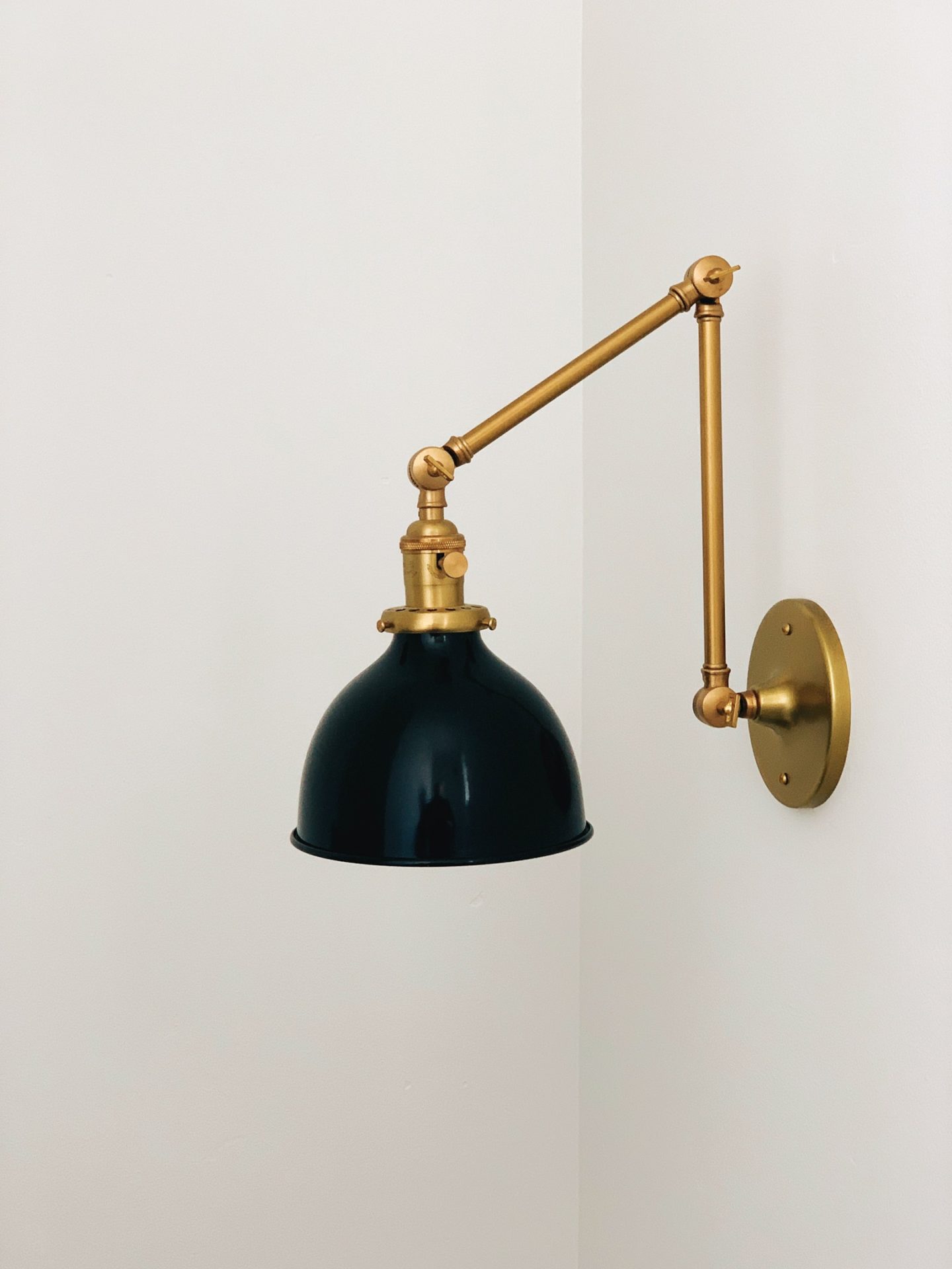 Unique wall light in brass and black for minimalist design