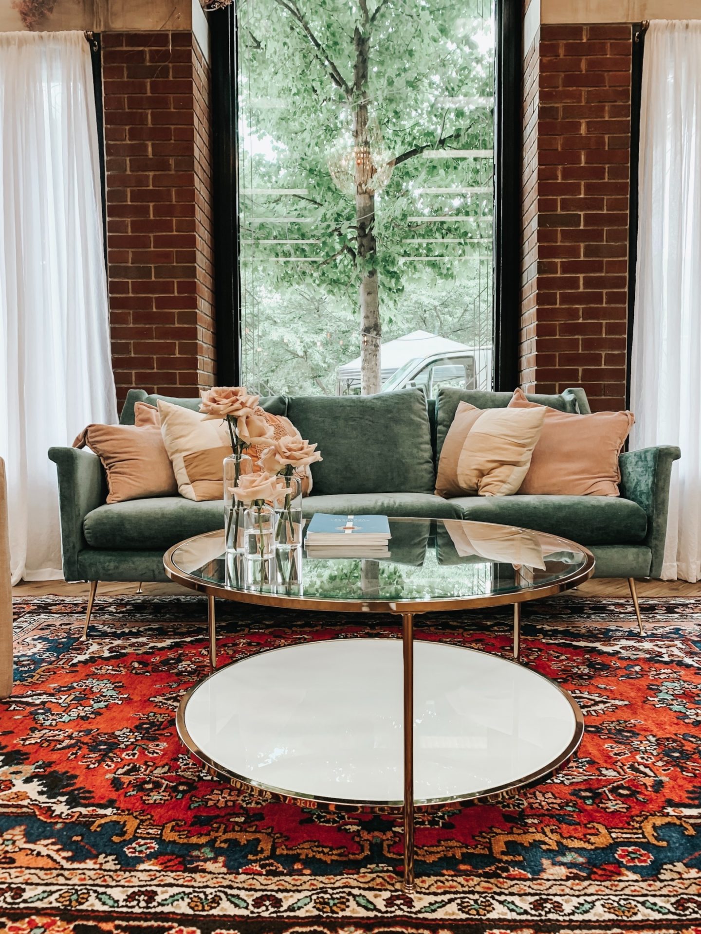 Bold color pattern rug with sea foam green mid-century sofa