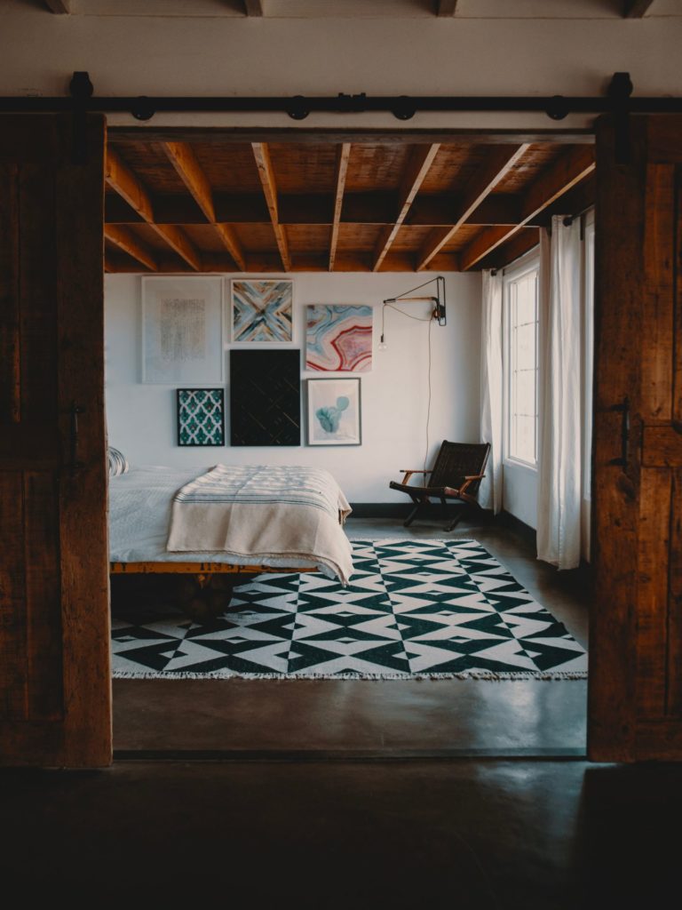 Bohemian bedroom with eclectic art on wall