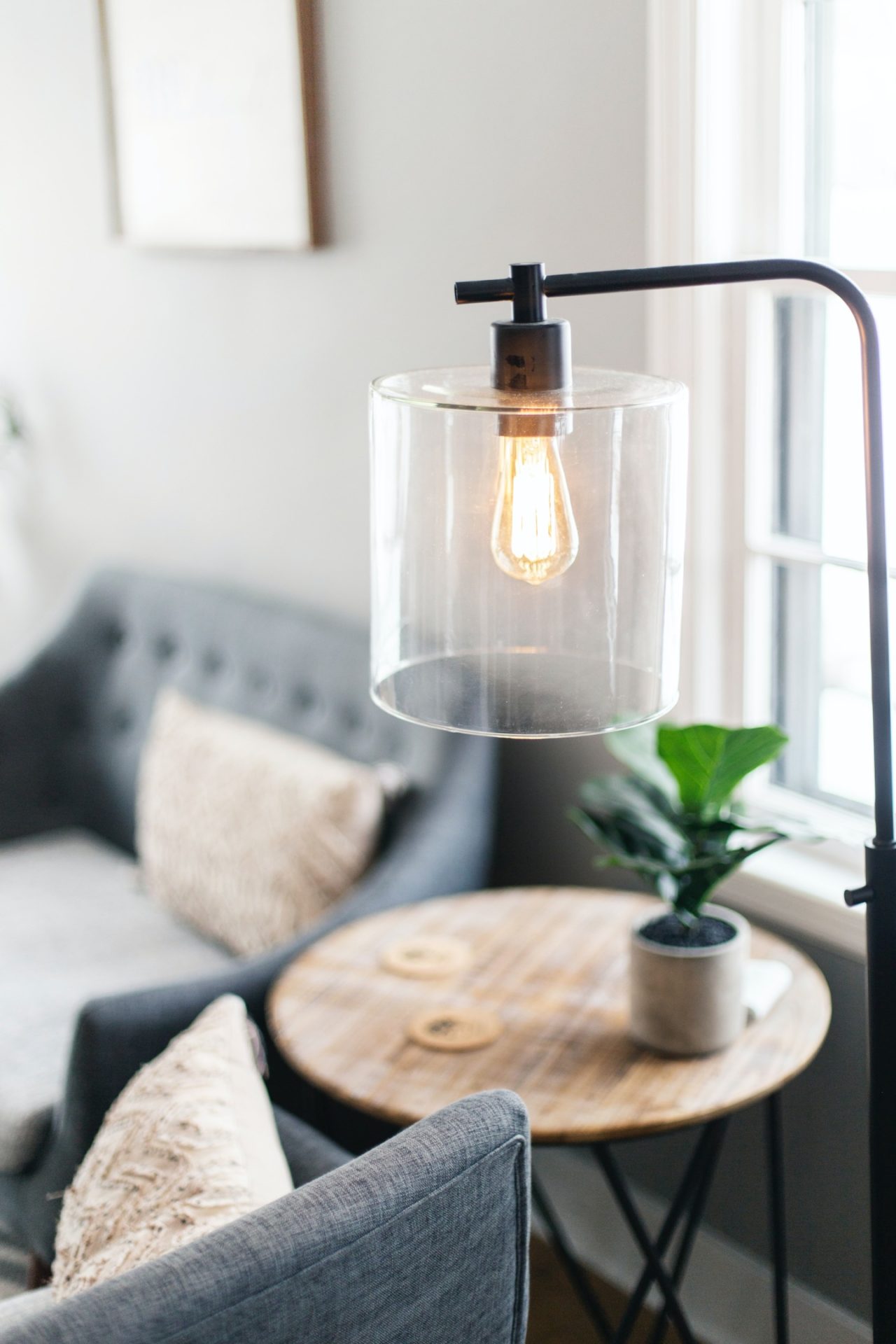 Modern black metal and glass floor lamp in a mid-century living room