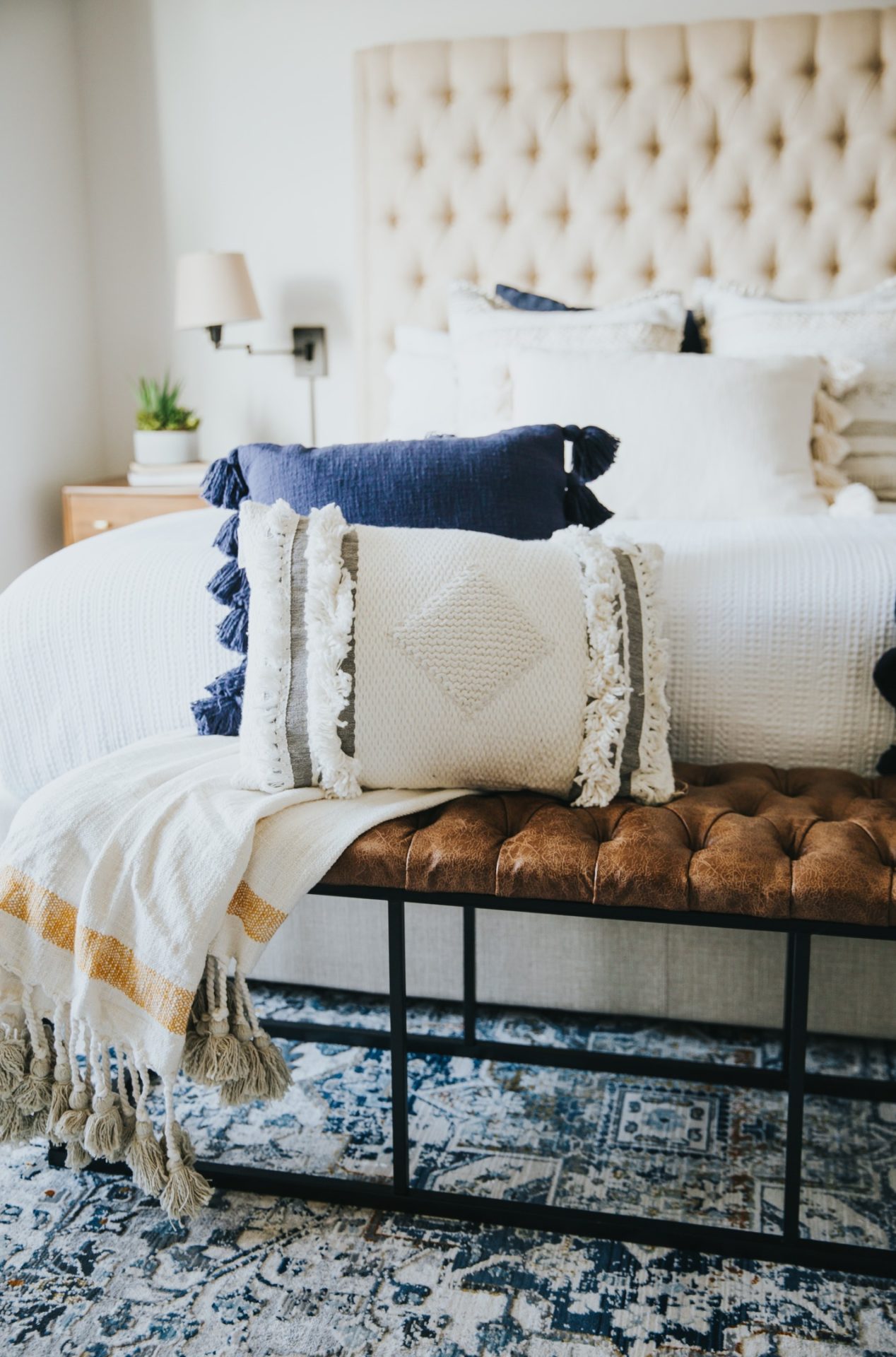 Various textured pillows and throw on a bed