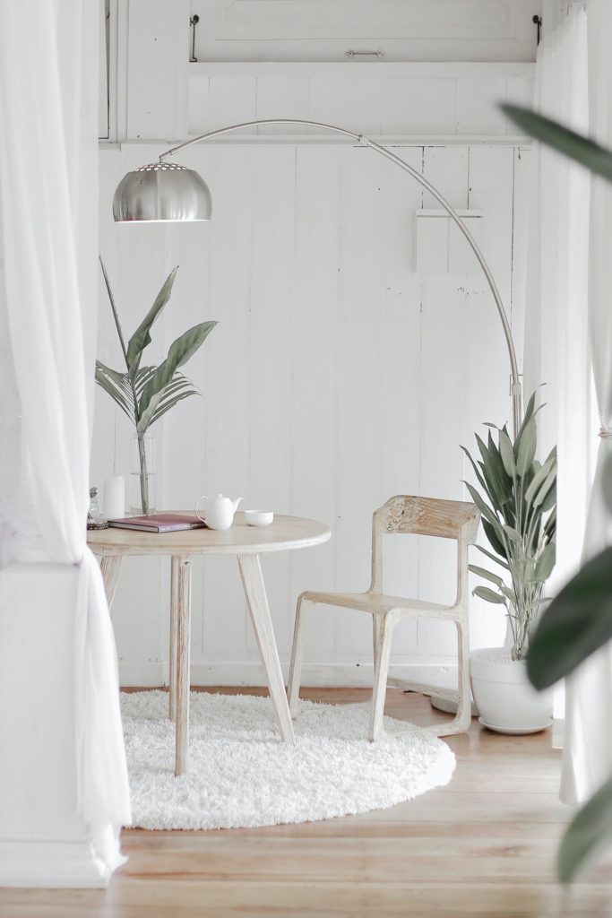 White washed table and chair in a bedroom