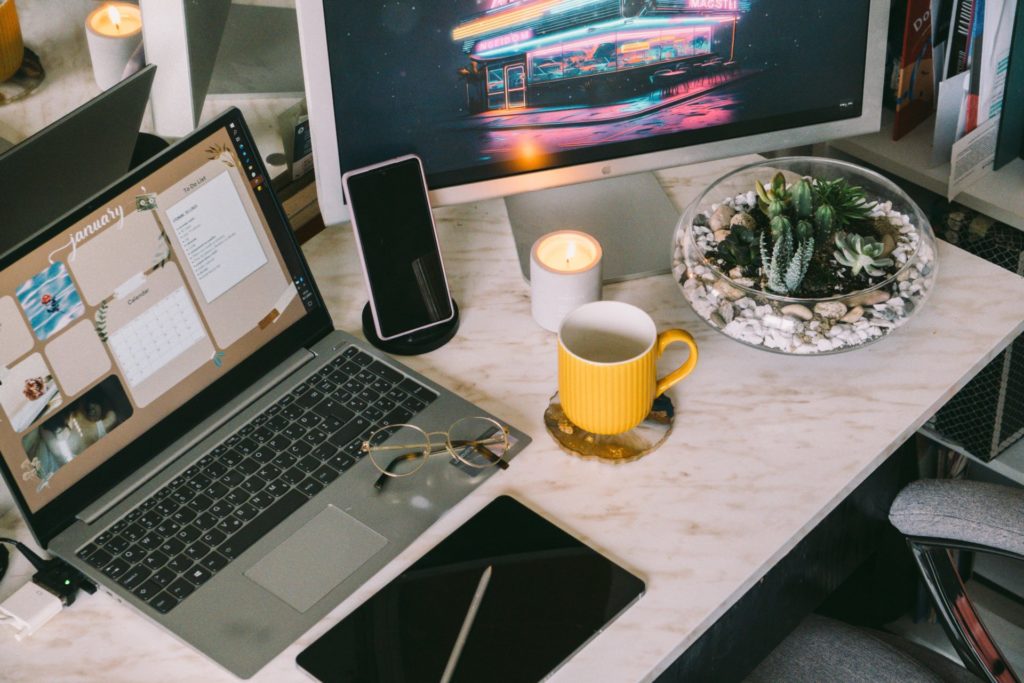 Home office space with candle and succulents