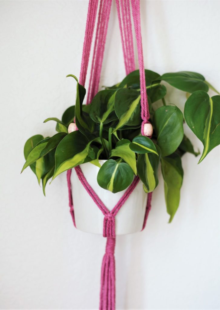 Bright pink macrame pot holder